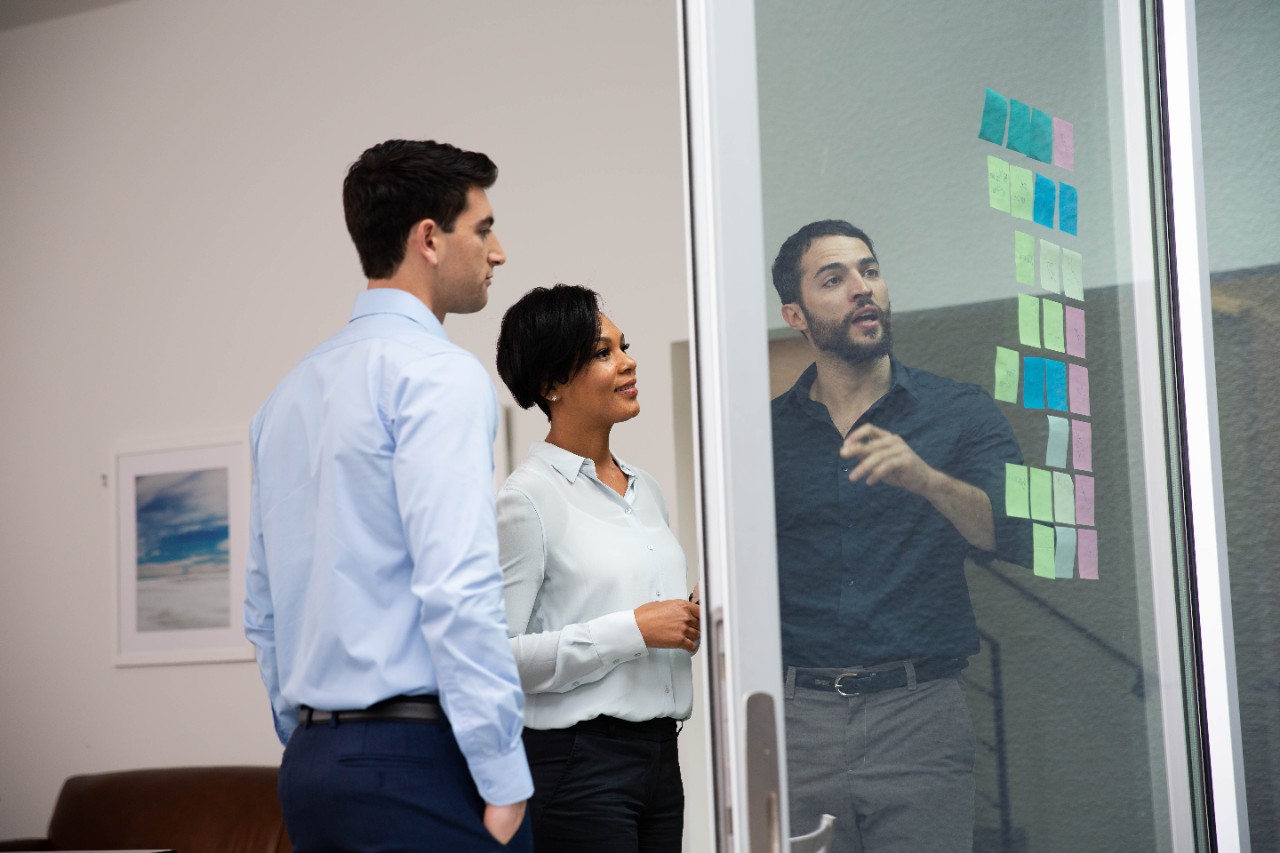 Team meeting with sticky notes on window